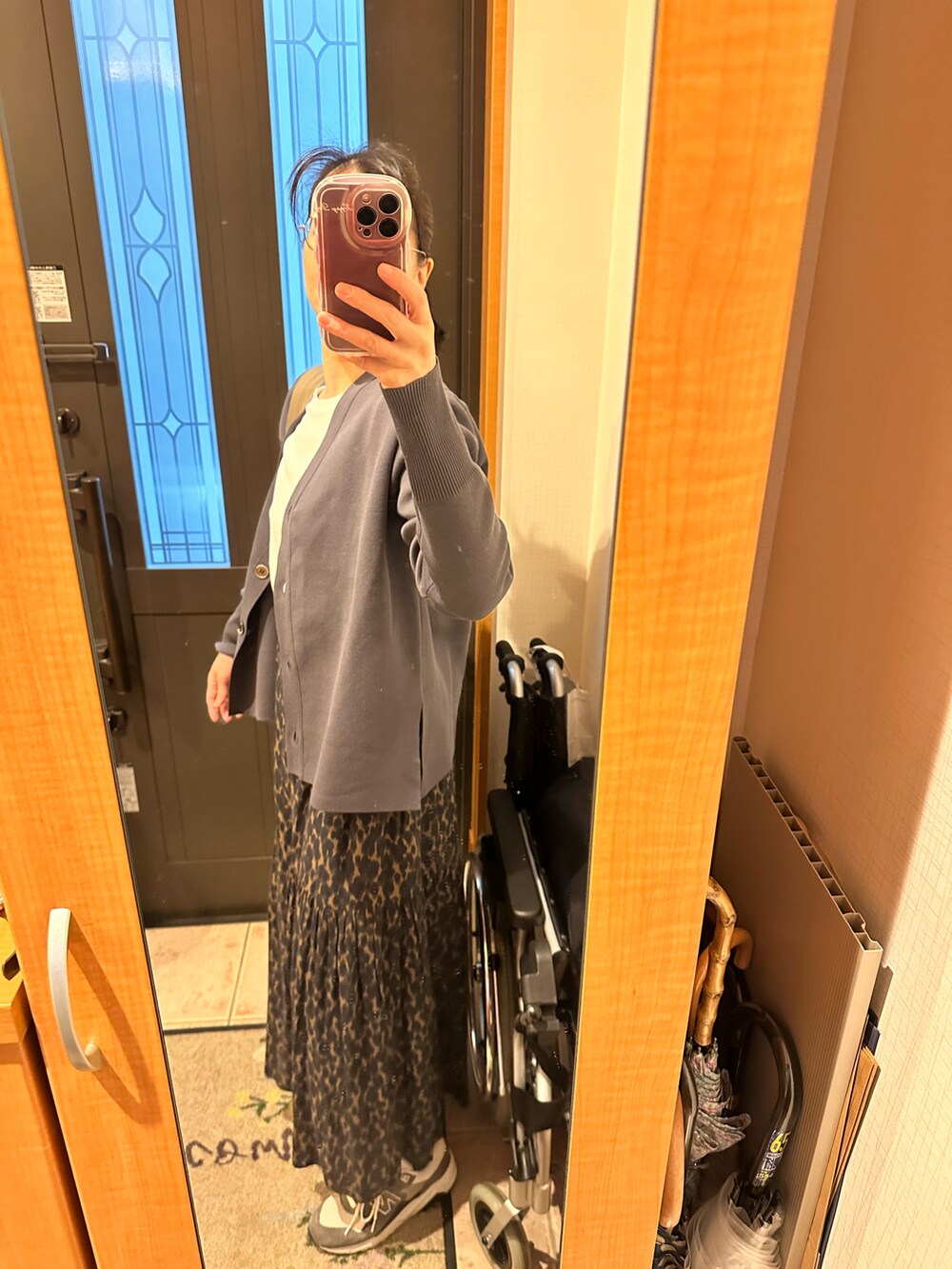 グレー系のカーディガン/ボレロ、ホワイト系のTシャツ/カットソー、グリーン系のスカートを着用したレディースの冬コーディネートの2枚目の写真