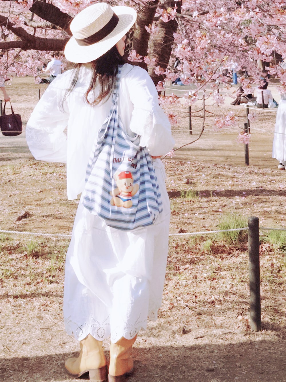 ホワイト系のスカート、ホワイト系のシャツ/ブラウス、イエロー系のブーツを着用したレディースの冬コーディネートの2枚目の写真