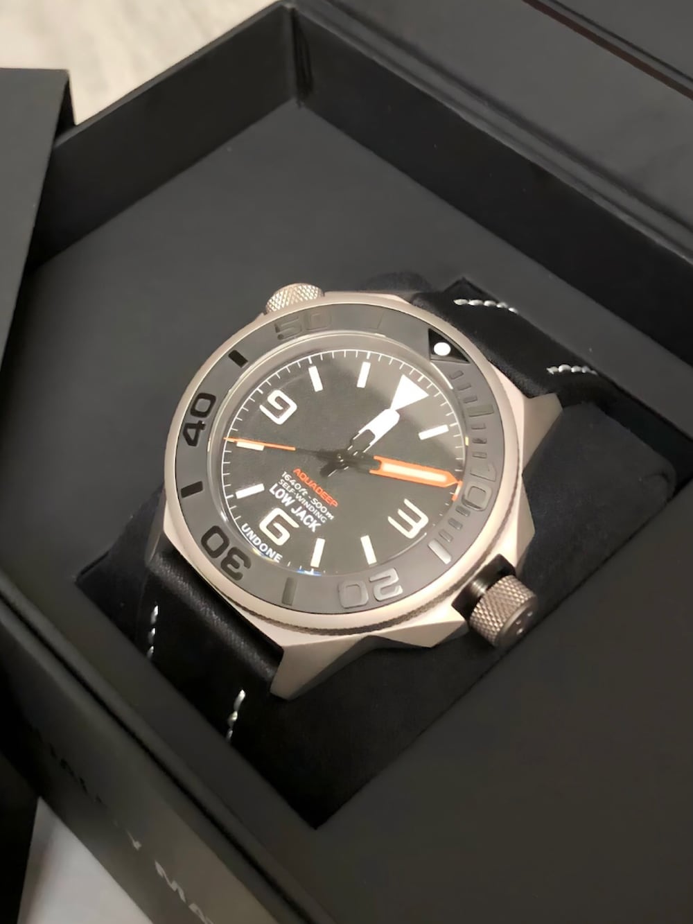 ホワイト系のポロシャツ、ブラック系のサンダル、ブラック系の腕時計を着用したメンズの夏コーディネートの2枚目の写真