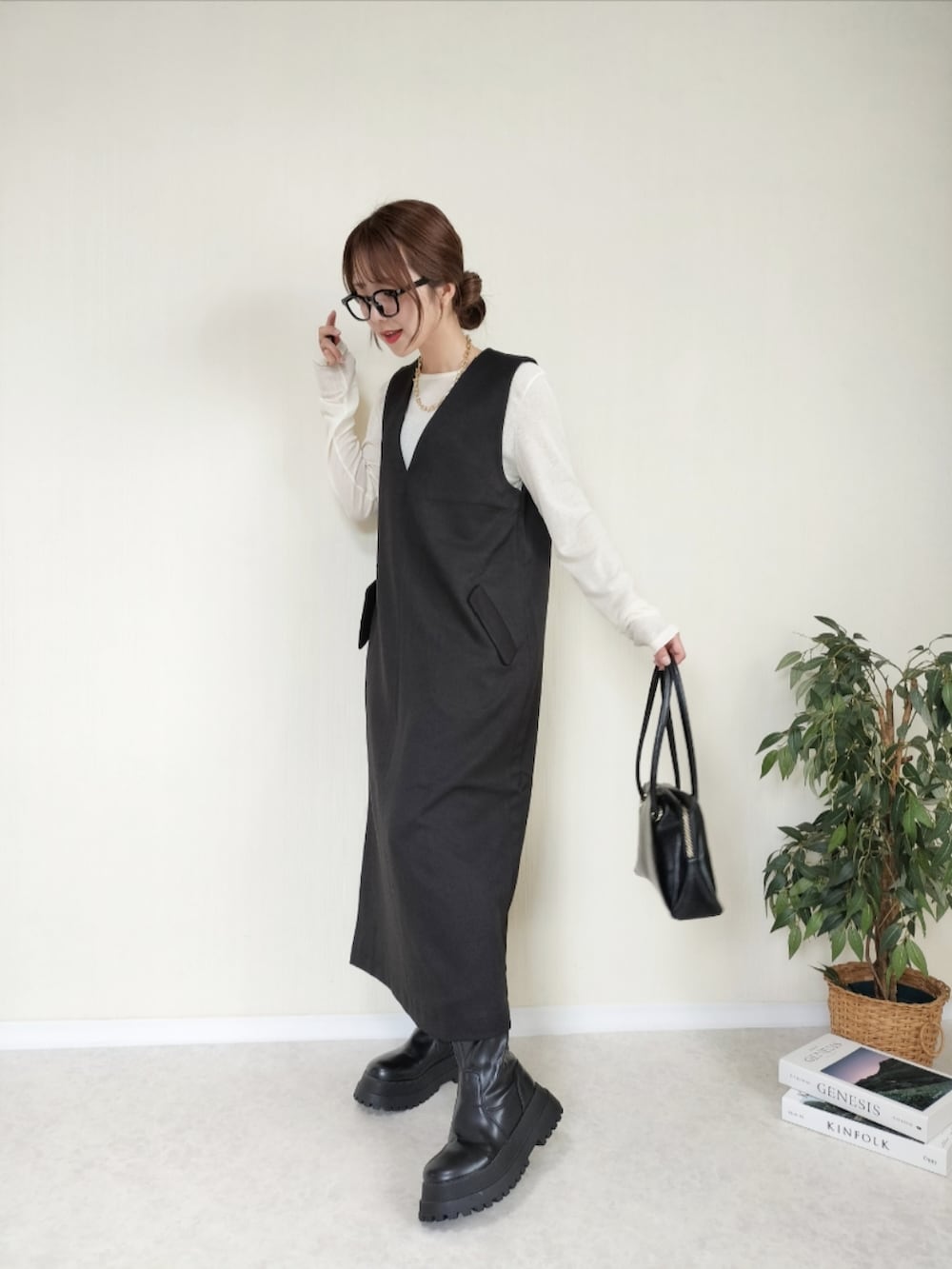 ブラック系のハンドバッグ、ブラック系のワンピースを着用したレディースの夏コーディネートの2枚目の写真