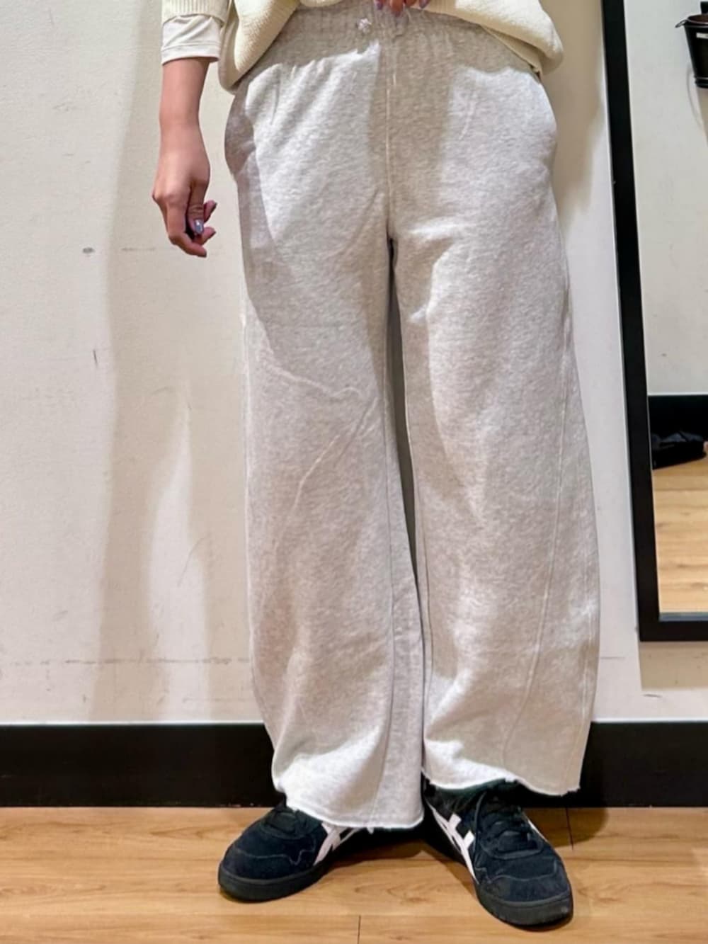 ホワイト系のTシャツ/カットソー、ホワイト系のニット/セーター、グレー系のスウェットパンツを着用したレディースの冬コーディネートの4枚目の写真