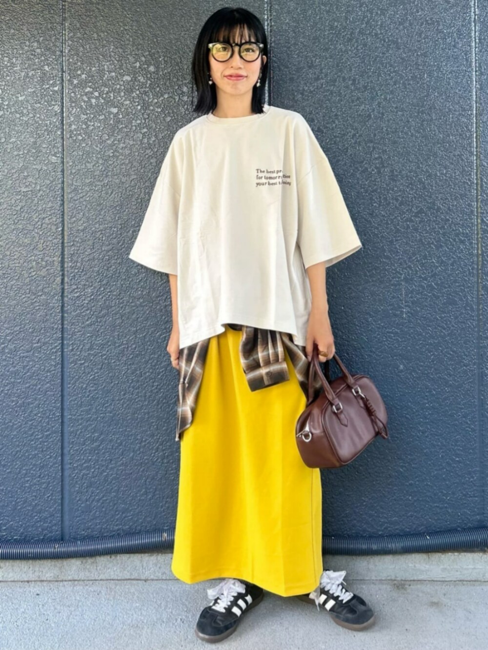 イエロー系のスカート、ホワイト系のTシャツ/カットソー、ブラウン系のシャツ/ブラウスを着用したレディースの秋コーディネートの2枚目の写真