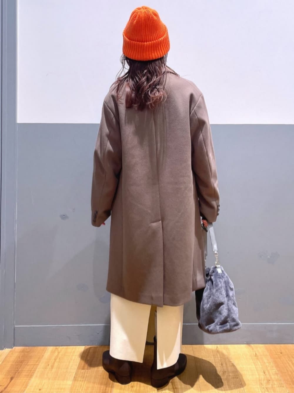 ホワイト系のTシャツ/カットソー、ベージュ系のショルダーバッグ、ブラック系のブーツを着用したレディースの冬コーディネートの3枚目の写真