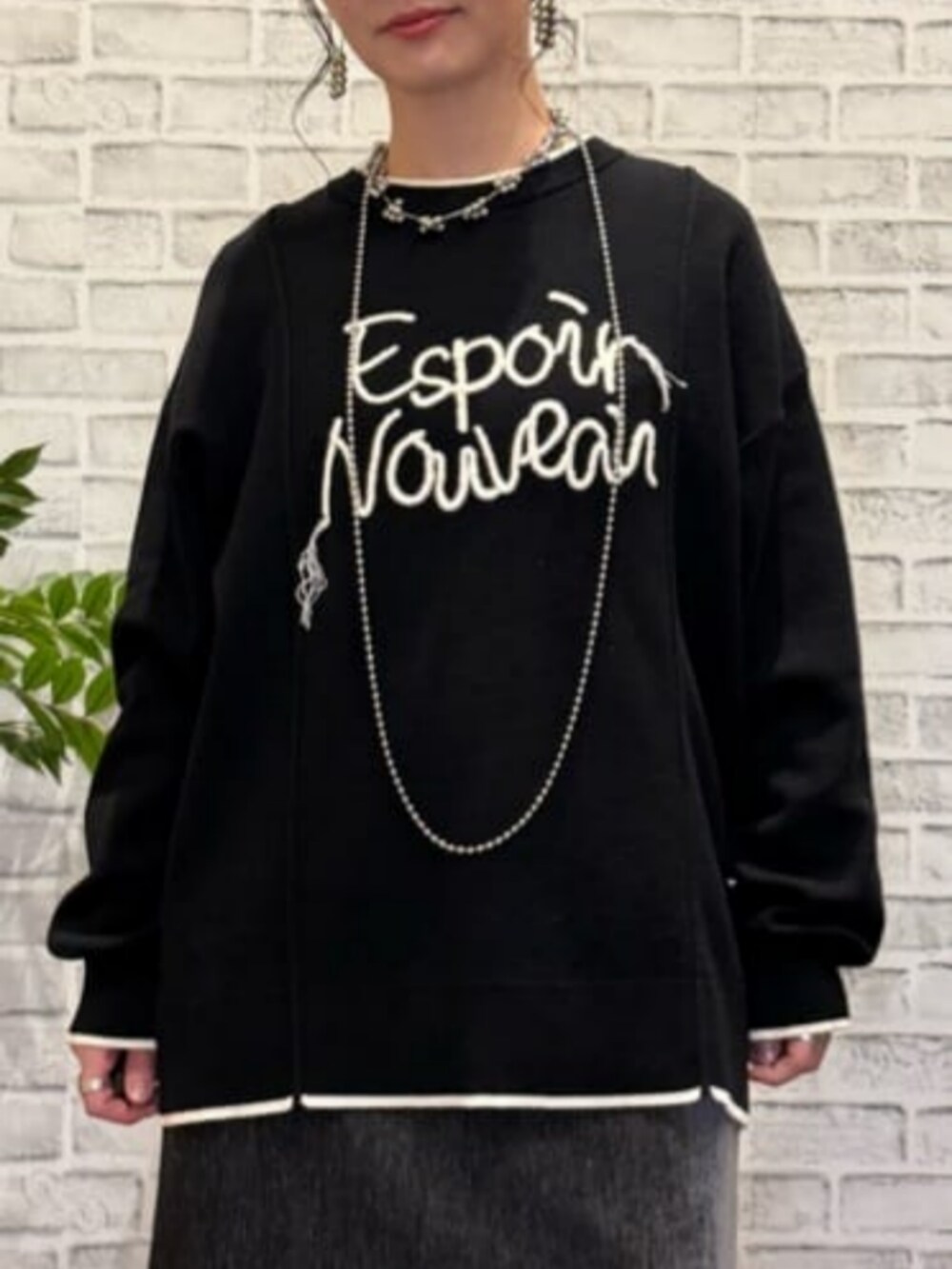 グレー系のスカート、ブラウン系のベスト、ブラック系のニット/セーターを着用したレディースの秋コーディネートの5枚目の写真