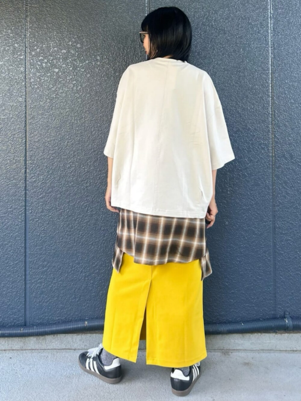 イエロー系のスカート、ホワイト系のTシャツ/カットソー、ブラウン系のシャツ/ブラウスを着用したレディースの秋コーディネートの4枚目の写真