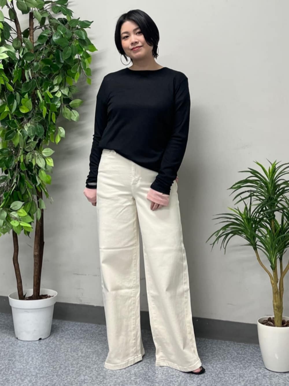 ホワイト系のトートバッグ、ベージュ系のマウンテンパーカー、ホワイト系のデニムパンツを着用したレディースの春コーディネートの4枚目の写真