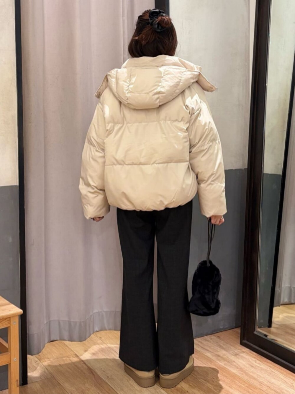 グレー系のその他パンツ、ホワイト系のダウンジャケット/コート、ブラック系のショルダーバッグを着用したレディースの冬コーディネートの3枚目の写真