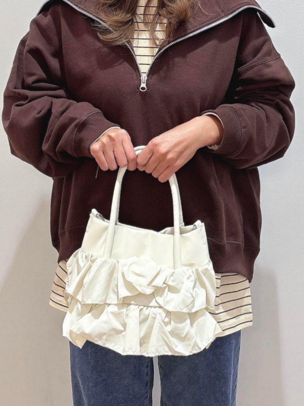 ピンク系のスウェット、ブルー系のその他トップス、ブルー系のデニムパンツを着用したレディースの冬コーディネートの10枚目の写真