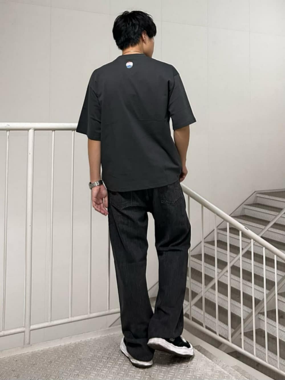 グレー系のTシャツ/カットソー、ブラック系のデニムパンツを着用したメンズの夏コーディネートの2枚目の写真