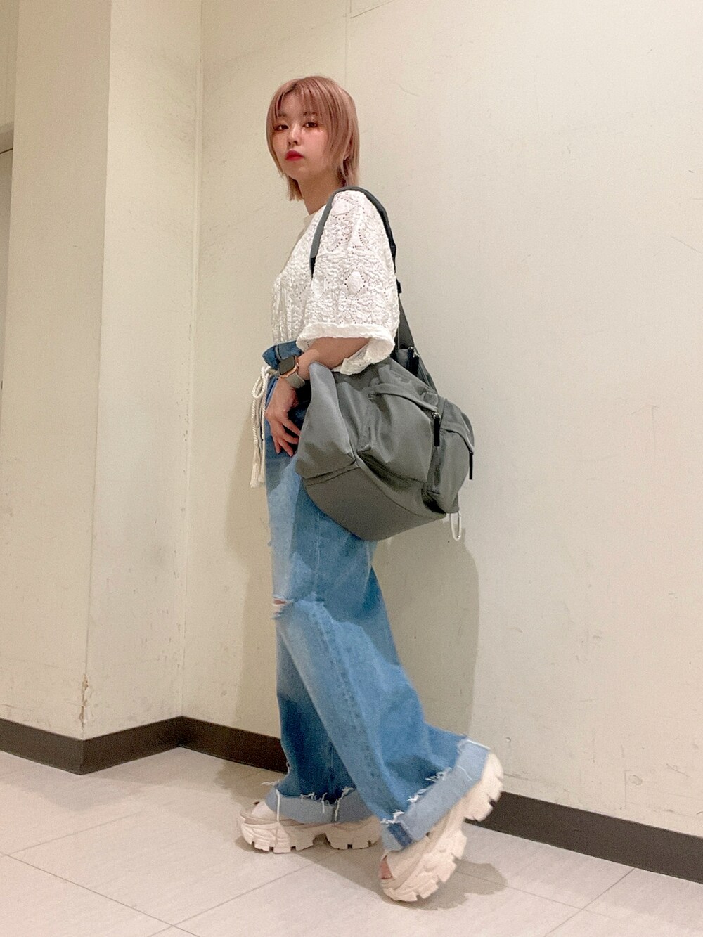 ホワイト系のTシャツ/カットソー、グリーン系のボディバッグ/ウエストポーチ、ブルー系のデニムパンツを着用したレディースの夏コーディネートの3枚目の写真