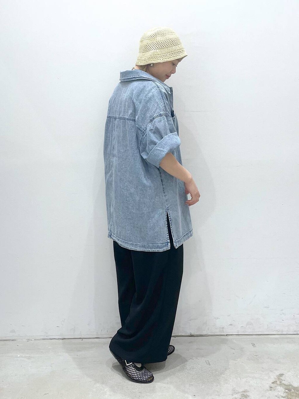 ブラック系のその他パンツ、ブラック系のパンプス、ブルー系のシャツ/ブラウスを着用したレディースの春コーディネートの2枚目の写真