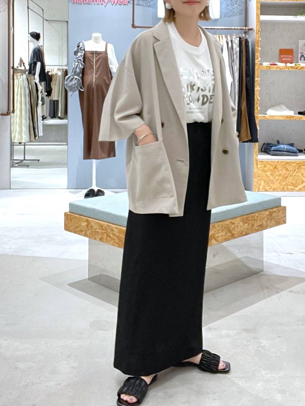 ベージュ系のテーラードジャケット、ブラック系のスカート、ホワイト系のTシャツ/カットソーを着用したレディースの夏コーディネートの4枚目の写真