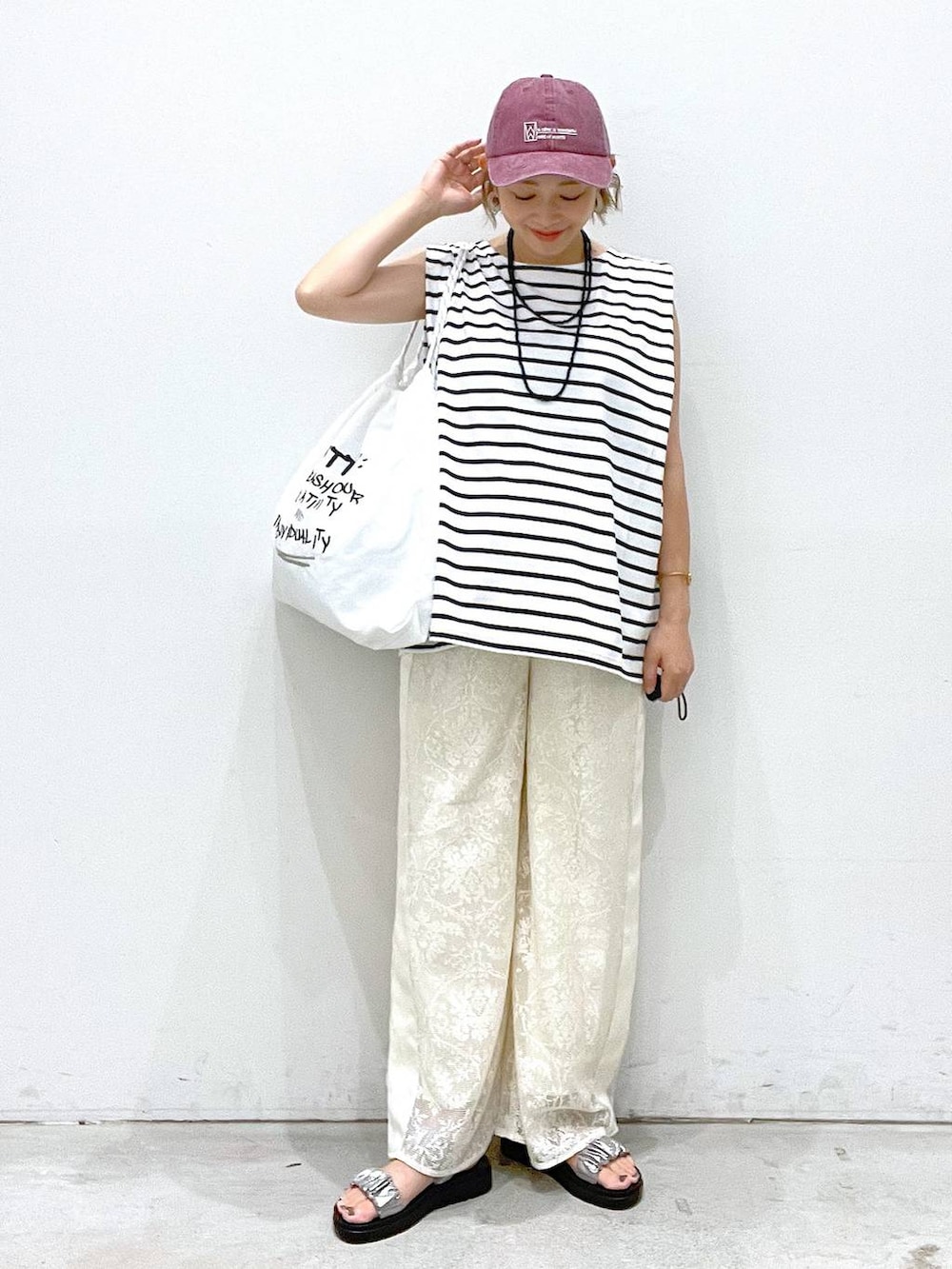 シルバー系のサンダル、ホワイト系のTシャツ/カットソー、ホワイト系のショルダーバッグを着用したレディースの夏コーディネートの4枚目の写真