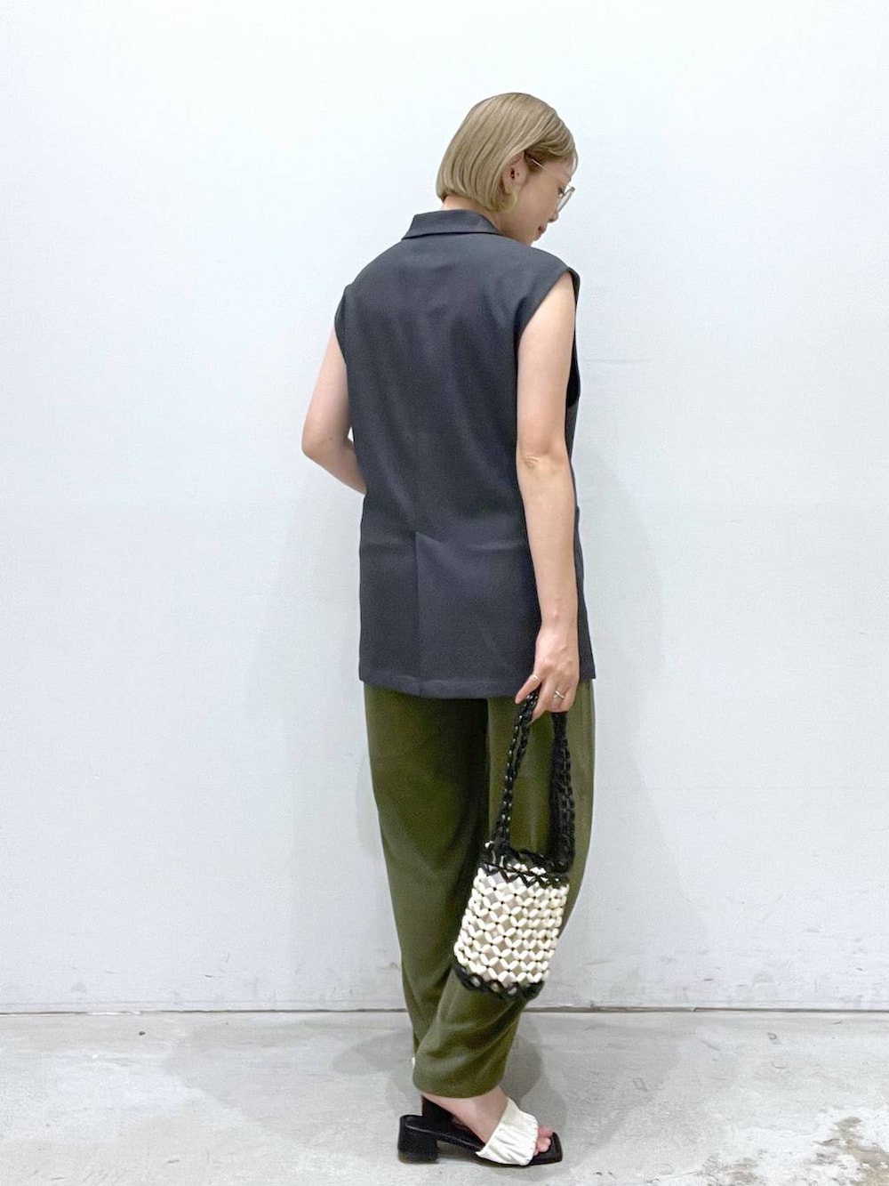 グリーン系のその他パンツ、ホワイト系のサンダル、ホワイト系のハンドバッグを着用したレディースの夏コーディネートの2枚目の写真