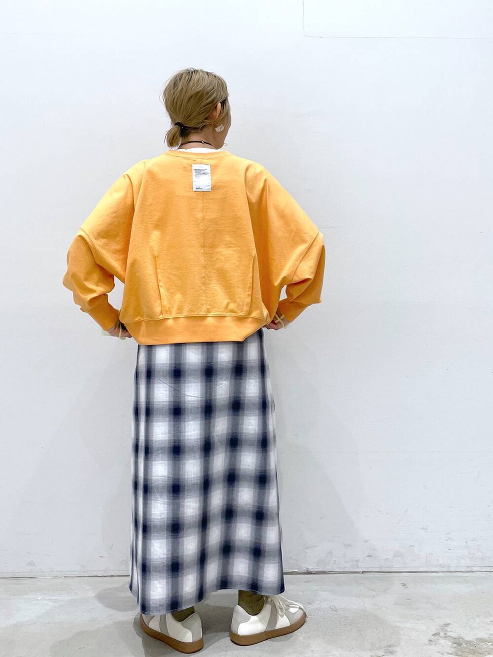 ホワイト系のTシャツ/カットソー、ブルー系のスカート、ホワイト系のスニーカーを着用したレディースの春コーディネートの3枚目の写真