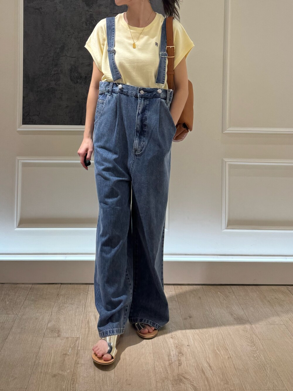 ベージュ系のTシャツ/カットソー、シルバー系のサンダル、ブルー系のデニムパンツを着用したレディースの夏コーディネートの2枚目の写真
