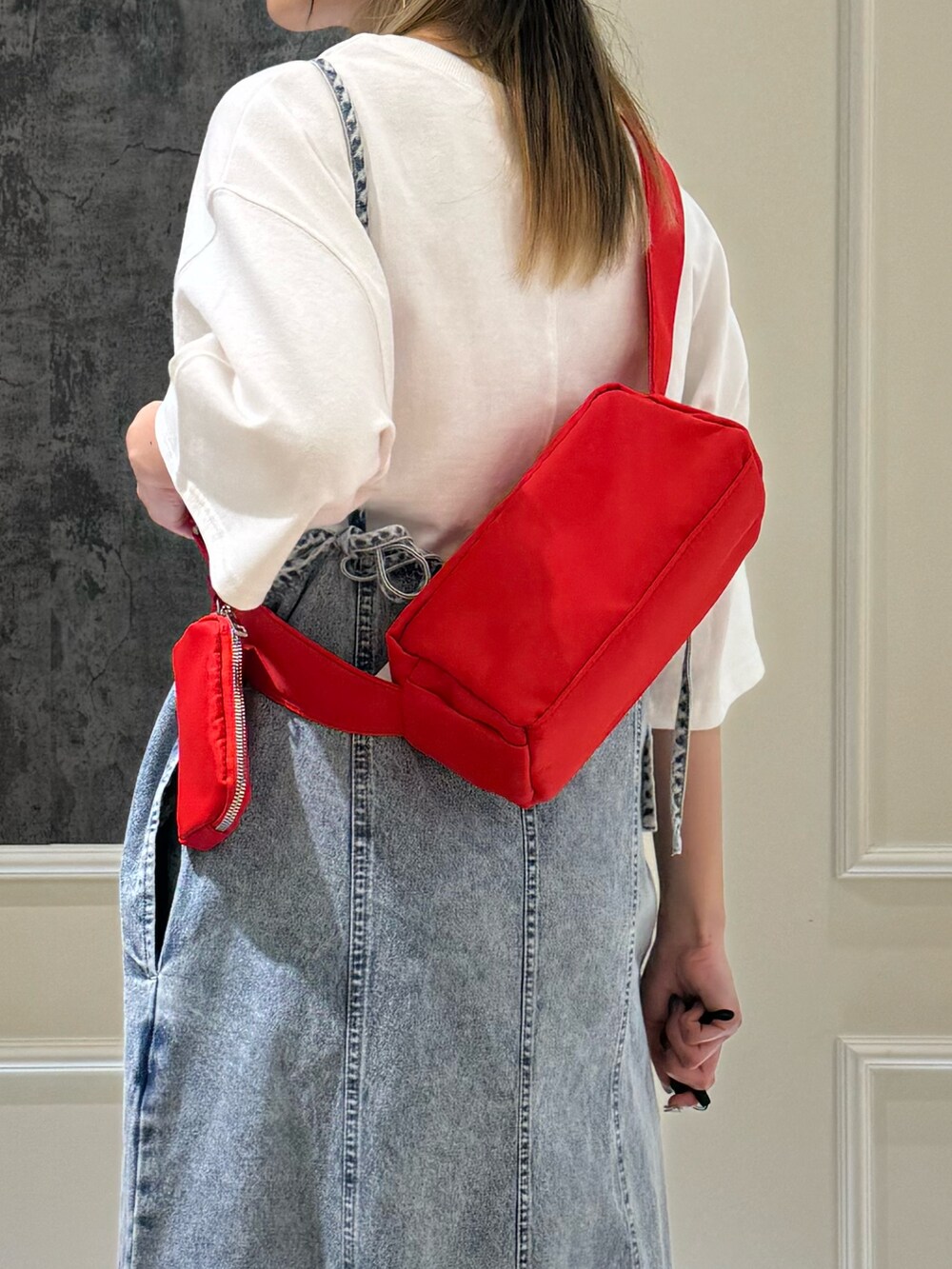 ブラック系のショルダーバッグ、ブルー系のワンピース、ホワイト系のTシャツ/カットソーを着用したレディースの夏コーディネートの3枚目の写真