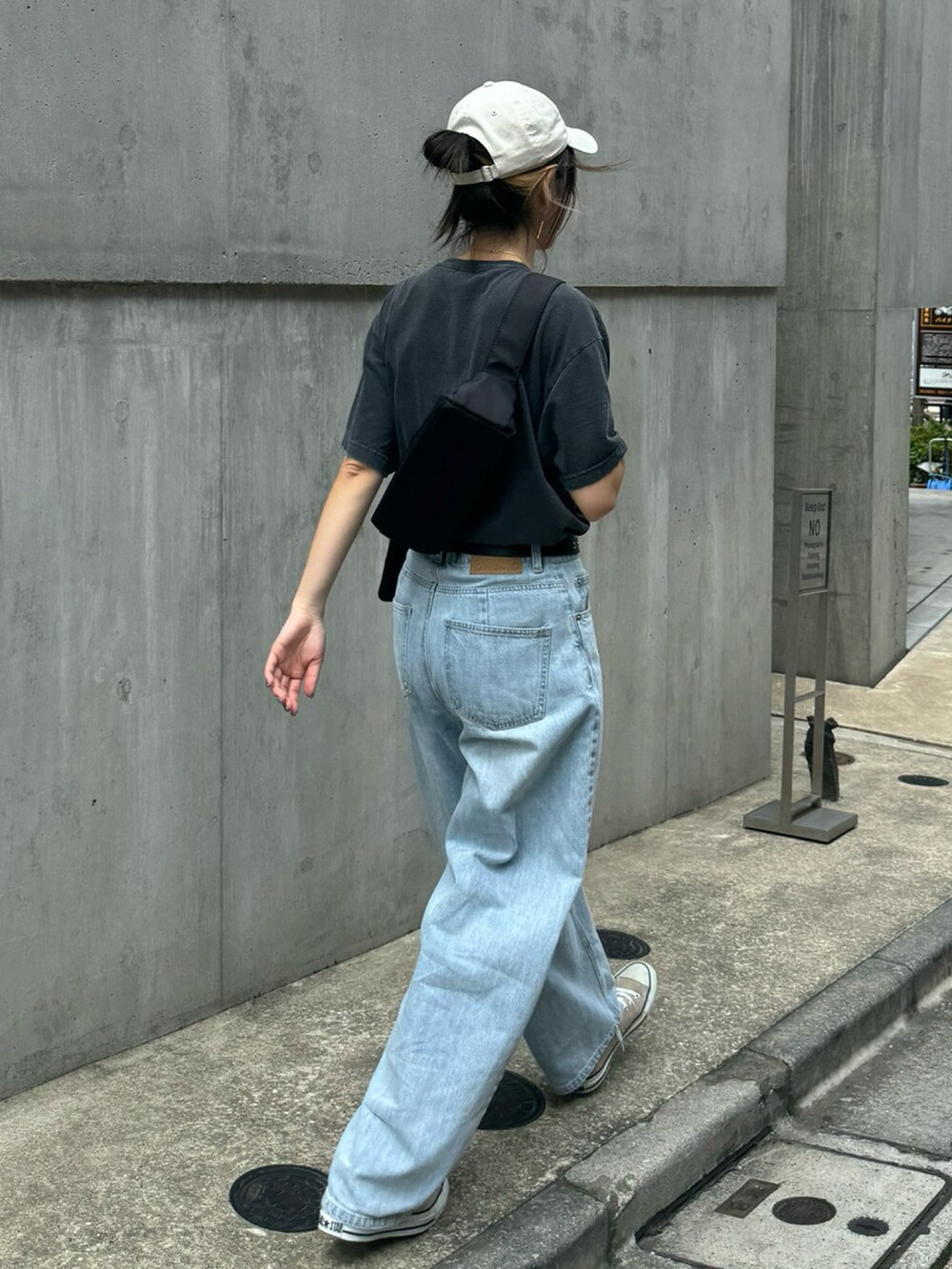 グレー系のTシャツ/カットソー、ブルー系のデニムパンツ、ブラック系のショルダーバッグを着用したレディースの夏コーディネートの5枚目の写真