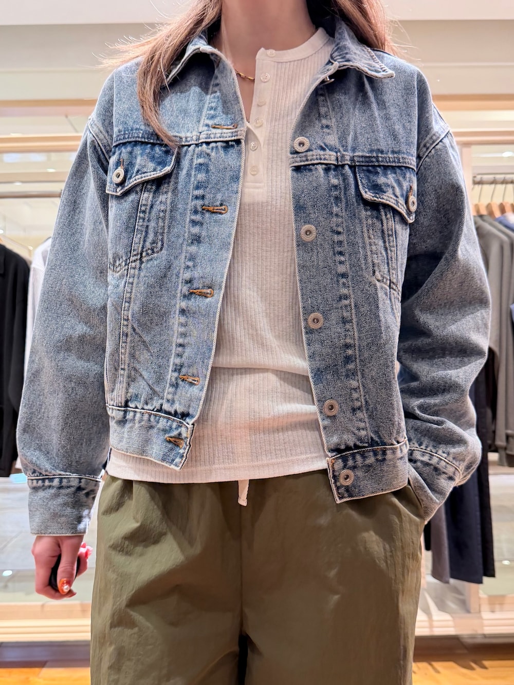 ブルー系のデニムジャケット、ホワイト系のTシャツ/カットソー、グリーン系のカーゴパンツを着用したレディースの春コーディネートの2枚目の写真