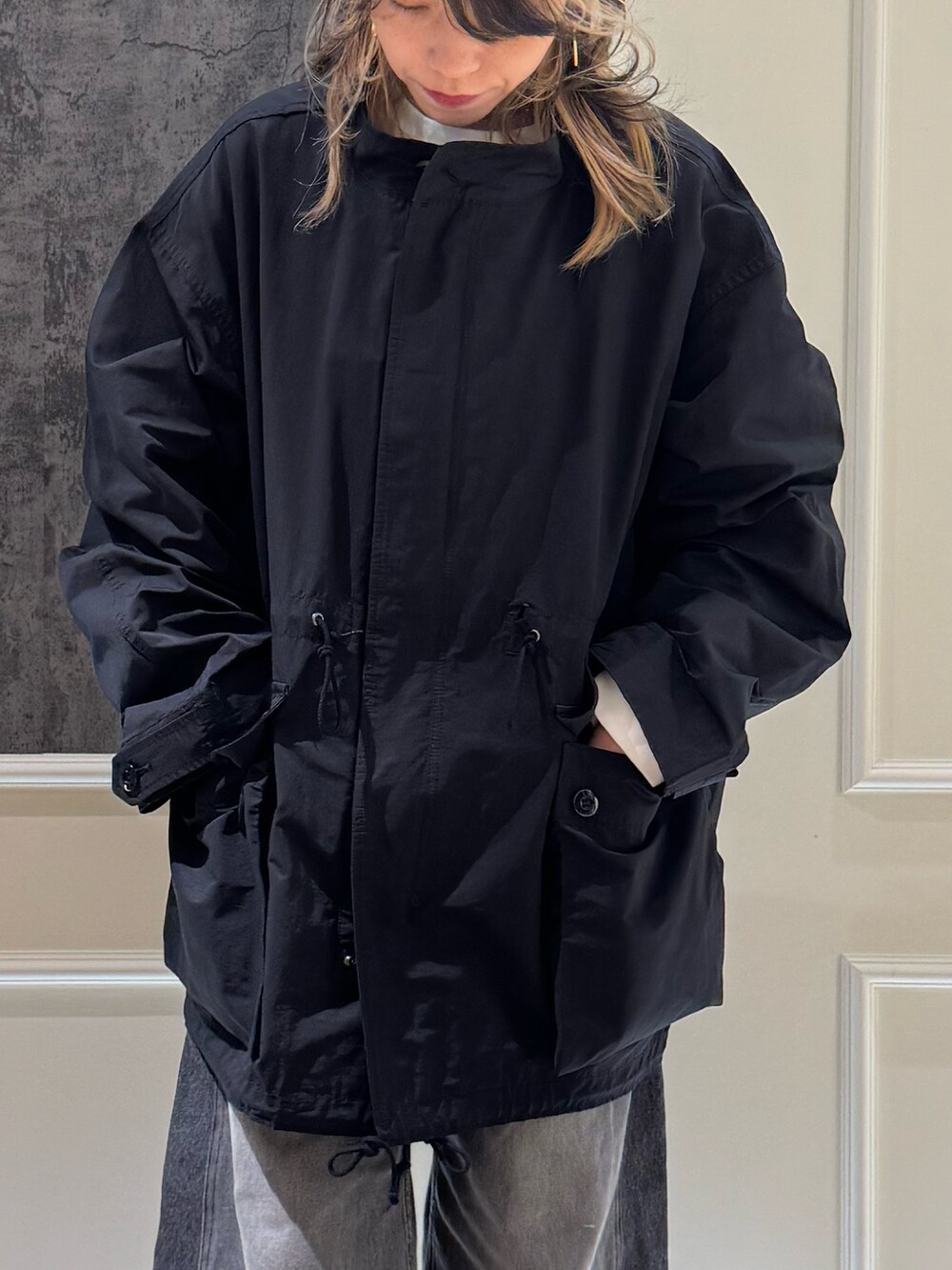 ブラック系のモッズコート、ブラック系のニットキャップ/ビーニーを着用したレディースの秋コーディネートの2枚目の写真