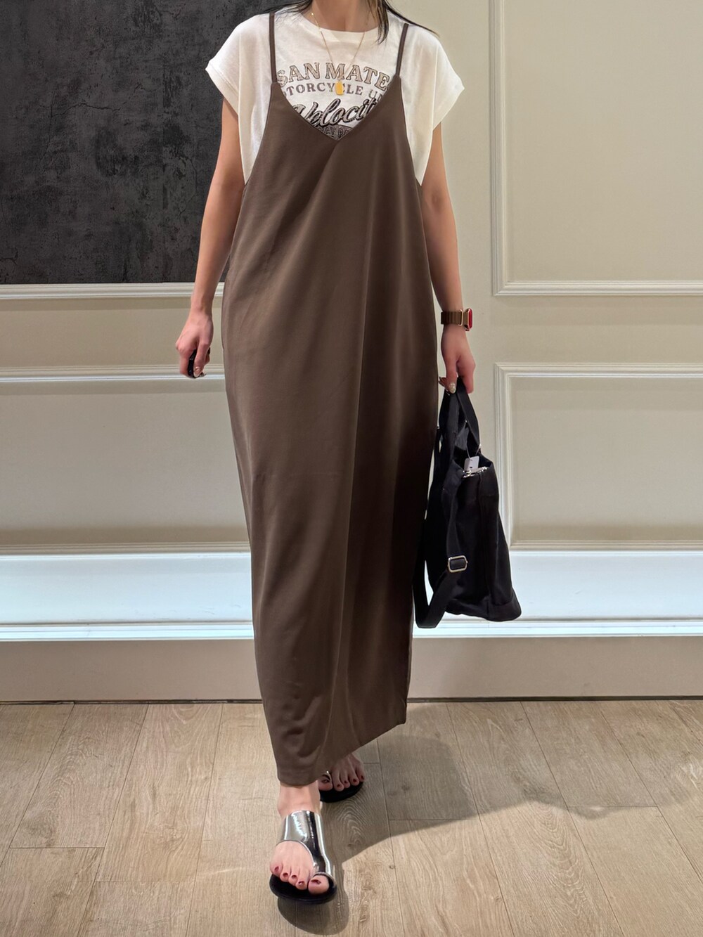 ブラウン系のワンピース、ブラック系のトートバッグ、シルバー系のサンダルを着用したレディースの夏コーディネートの2枚目の写真