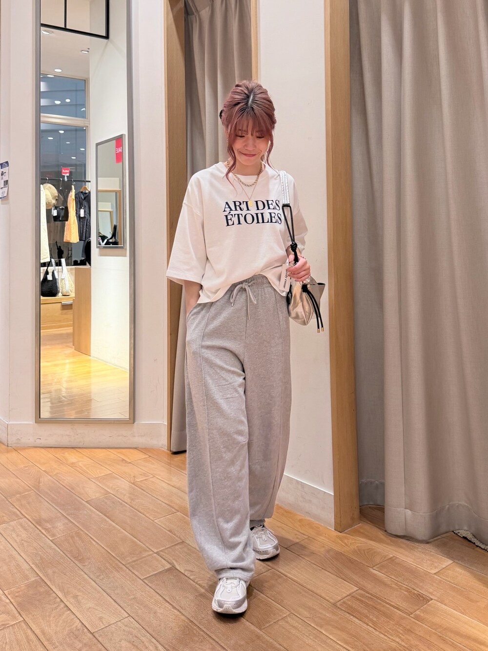 ホワイト系のTシャツ/カットソー、グレー系のその他パンツ、シルバー系のショルダーバッグを着用したレディースの夏コーディネートの3枚目の写真