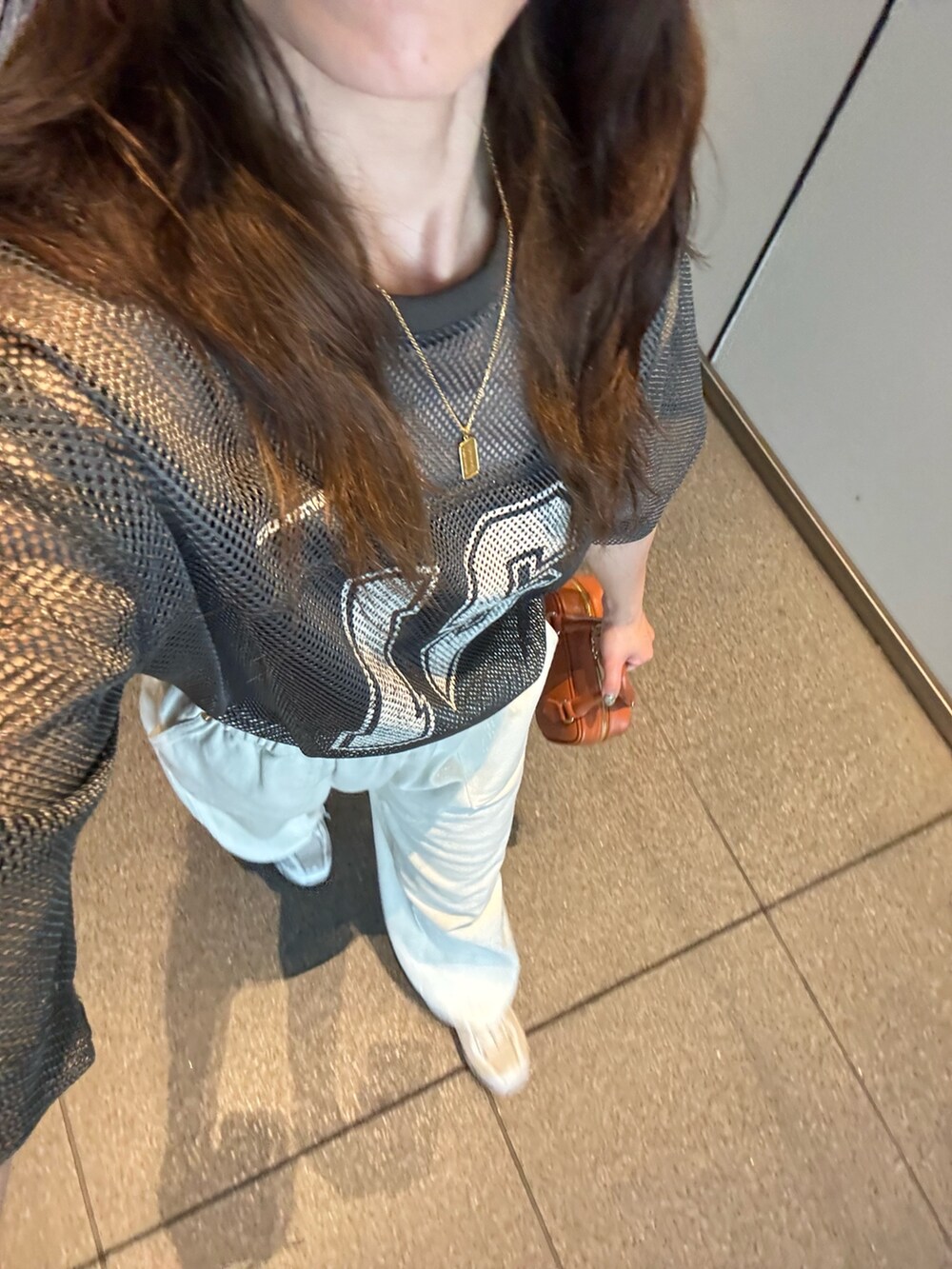 グレー系のTシャツ/カットソー、ブルー系のデニムパンツ、イエロー系のショルダーバッグを着用したレディースの夏コーディネートの3枚目の写真