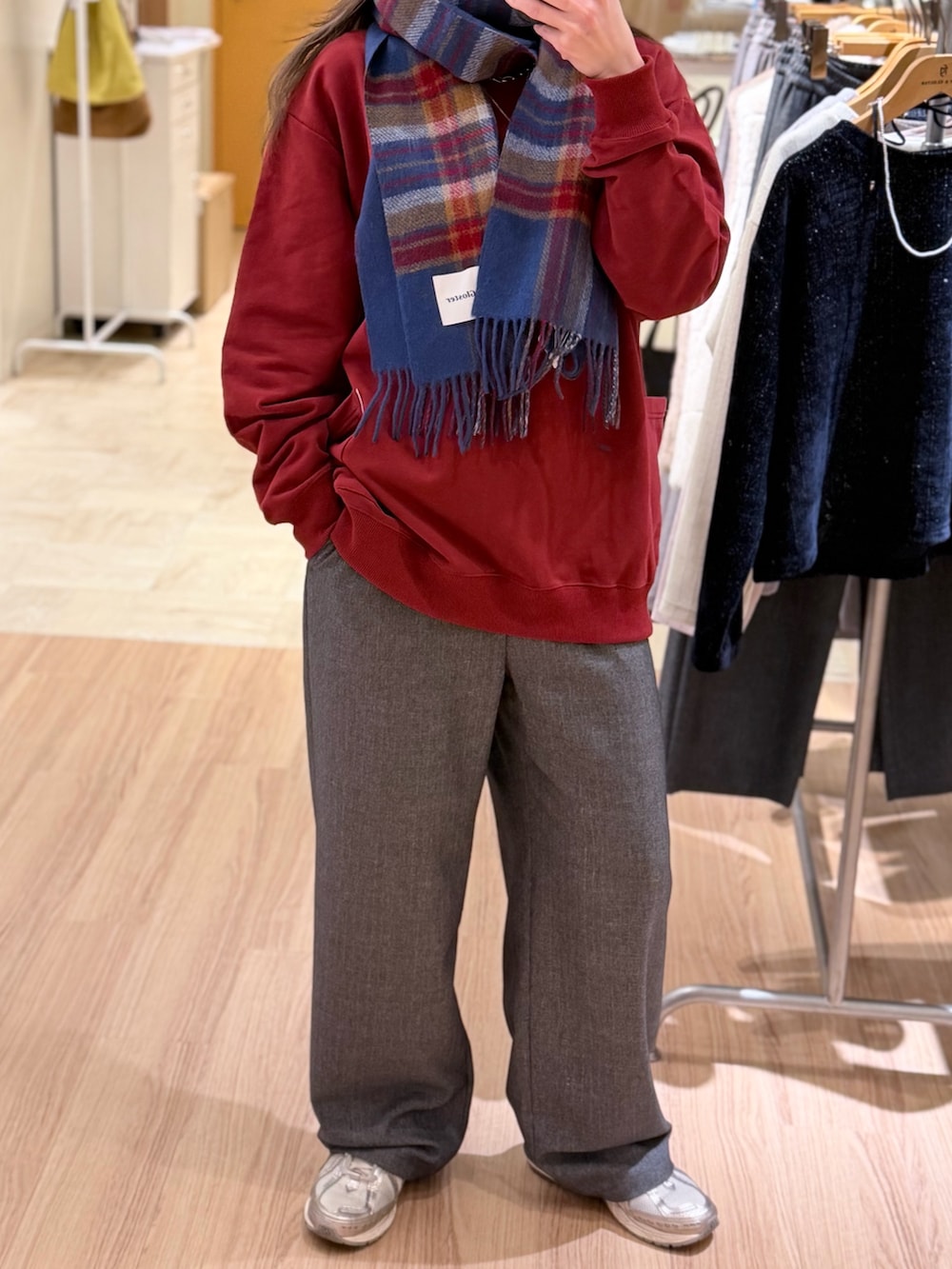 グレー系のその他パンツ、レッド系のスウェット、グリーン系のマフラーを着用したレディースの冬コーディネートの3枚目の写真