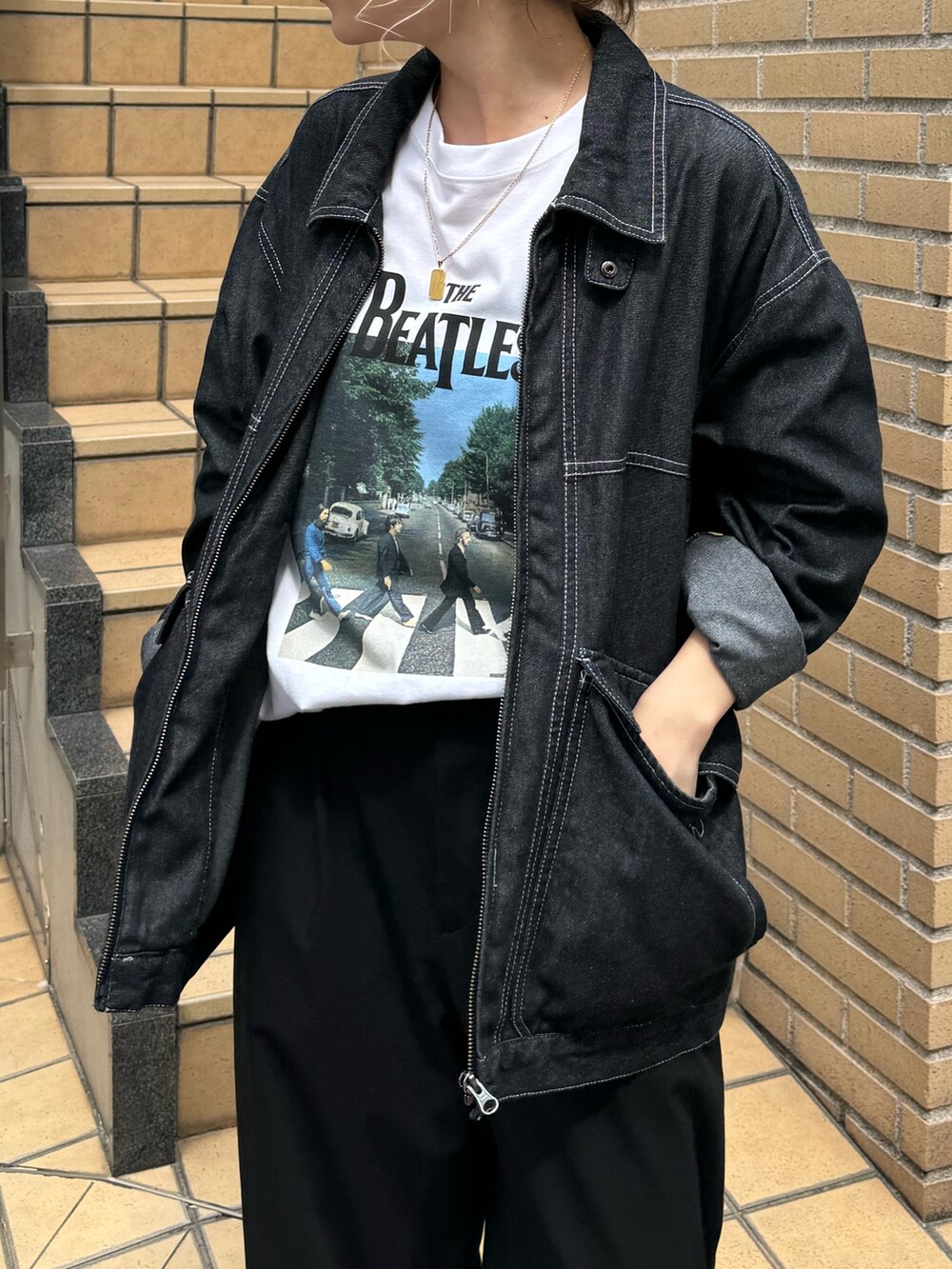 ブラック系のブルゾン、ホワイト系のTシャツ/カットソーを着用したレディースの秋コーディネートの4枚目の写真