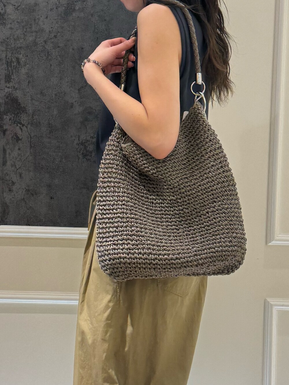 グレー系のタンクトップ、ベージュ系のその他パンツ、ホワイト系のキャップを着用したレディースの夏コーディネートの5枚目の写真