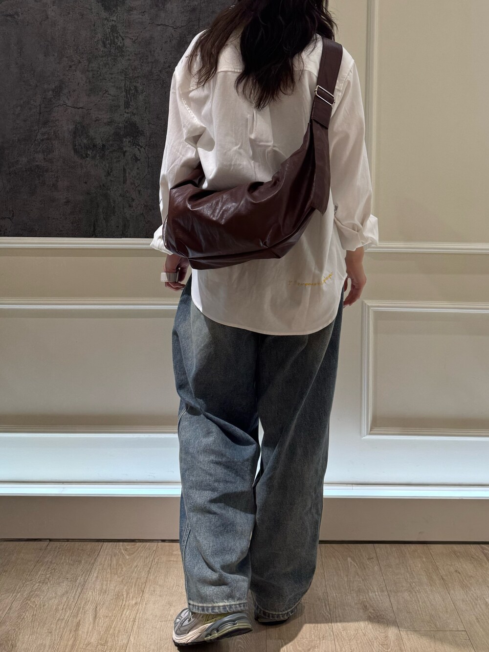 ホワイト系のシャツ/ブラウス、ブルー系のデニムパンツ、ブラウン系のショルダーバッグを着用したレディースの春コーディネートの4枚目の写真