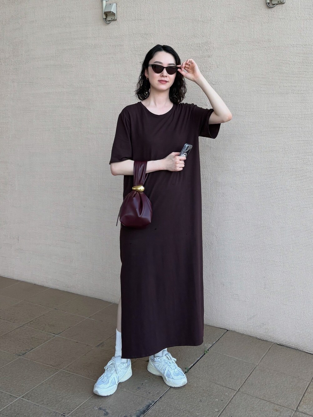 ブラウン系のワンピース/ドレス、ホワイト系のスニーカー、ホワイト系のソックス/靴下を着用したレディースの夏コーディネートの2枚目の写真