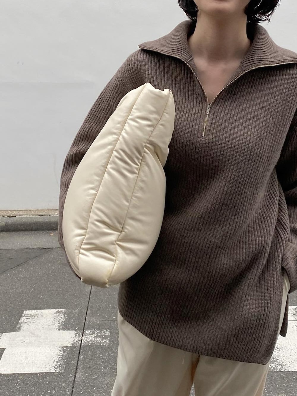 ホワイト系のバッグ、ホワイト系のパンツ、ホワイト系のスニーカーを着用したレディースの冬コーディネートの4枚目の写真