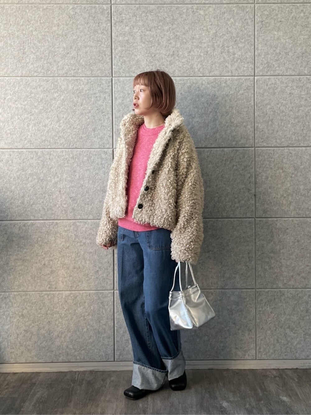 ピンク系のニット/セーター、ブルー系のデニムパンツを着用したレディースの冬コーディネートの3枚目の写真
