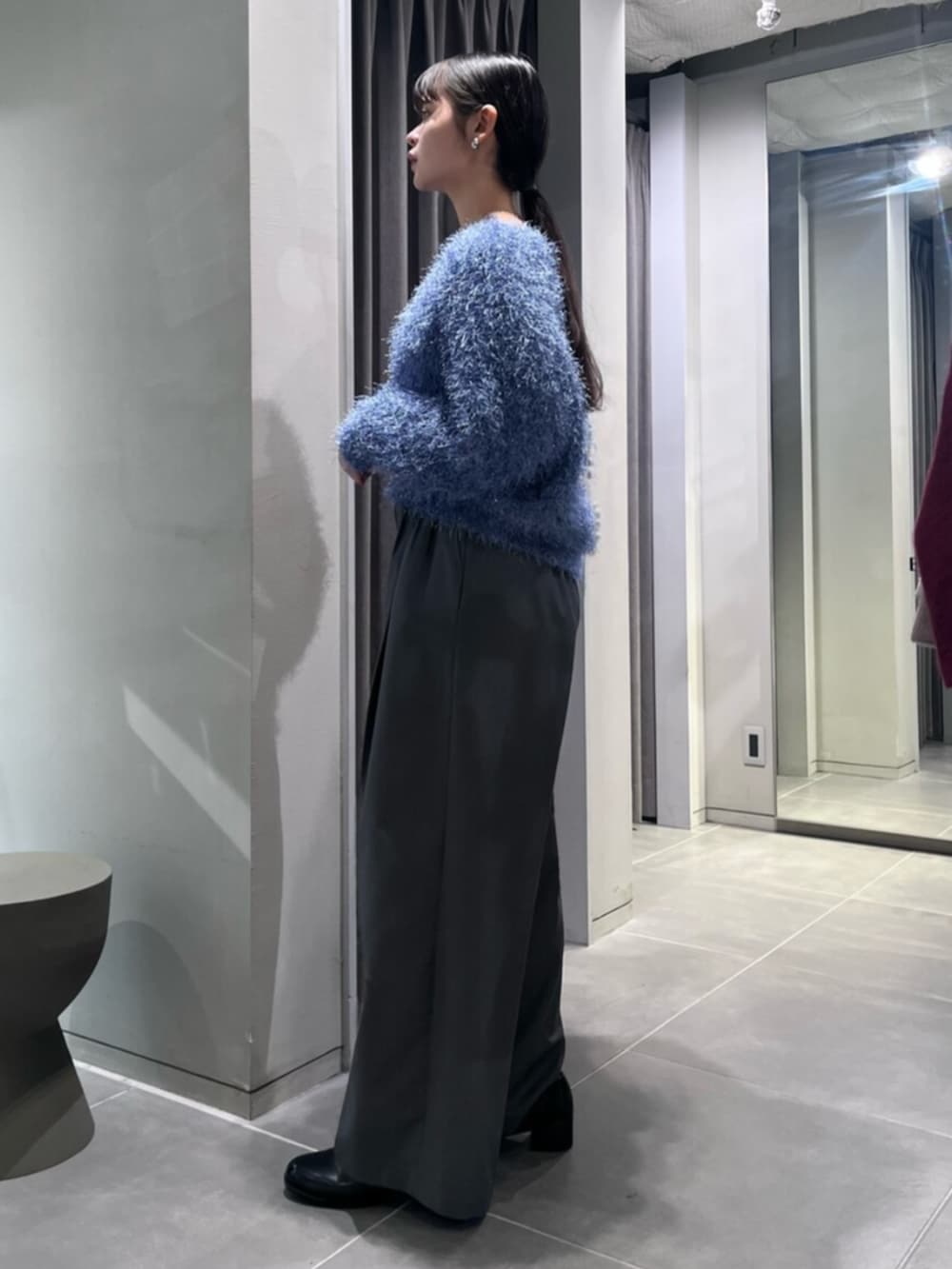 ブラック系のパンプス、ブルー系のニット/セーター、グレー系のその他パンツを着用したレディースの冬コーディネートの2枚目の写真