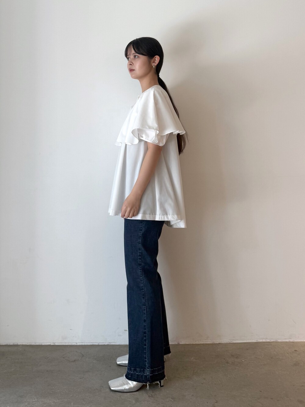 ホワイト系のシャツ/ブラウス、ブルー系のデニムパンツ、シルバー系のブーツを着用したレディースの夏コーディネートの6枚目の写真