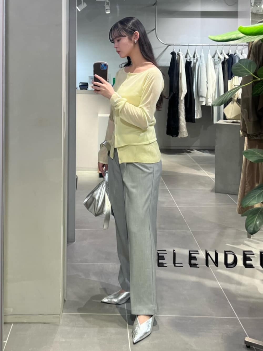 シルバー系のショルダーバッグ、シルバー系のパンプス、グレー系のその他パンツを着用したレディースの春コーディネートの2枚目の写真