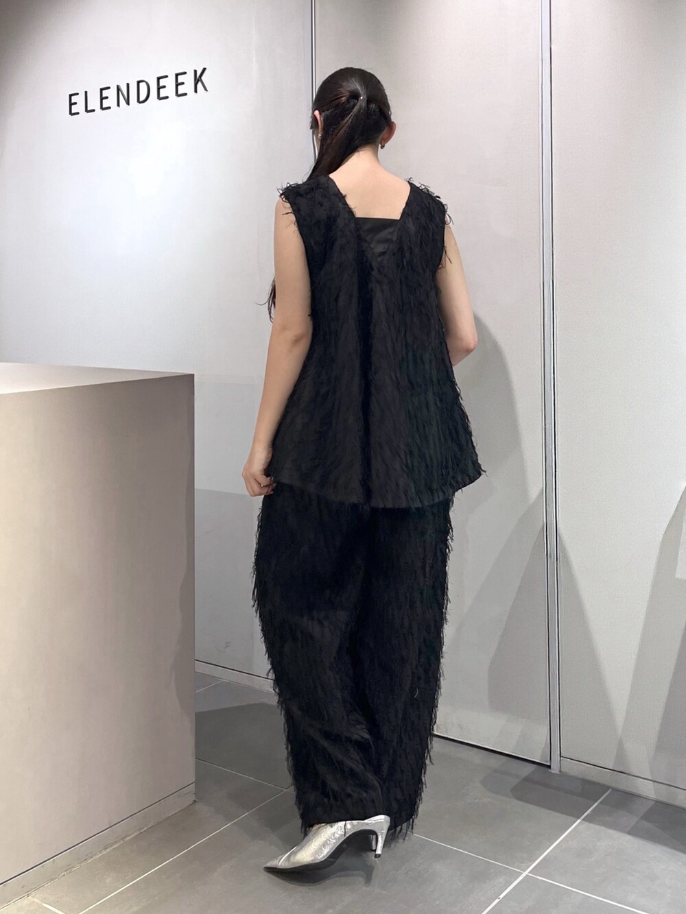 ブラック系のシャツ/ブラウス、ブラック系のその他パンツ、シルバー系のパンプスを着用したレディースの夏コーディネートの3枚目の写真