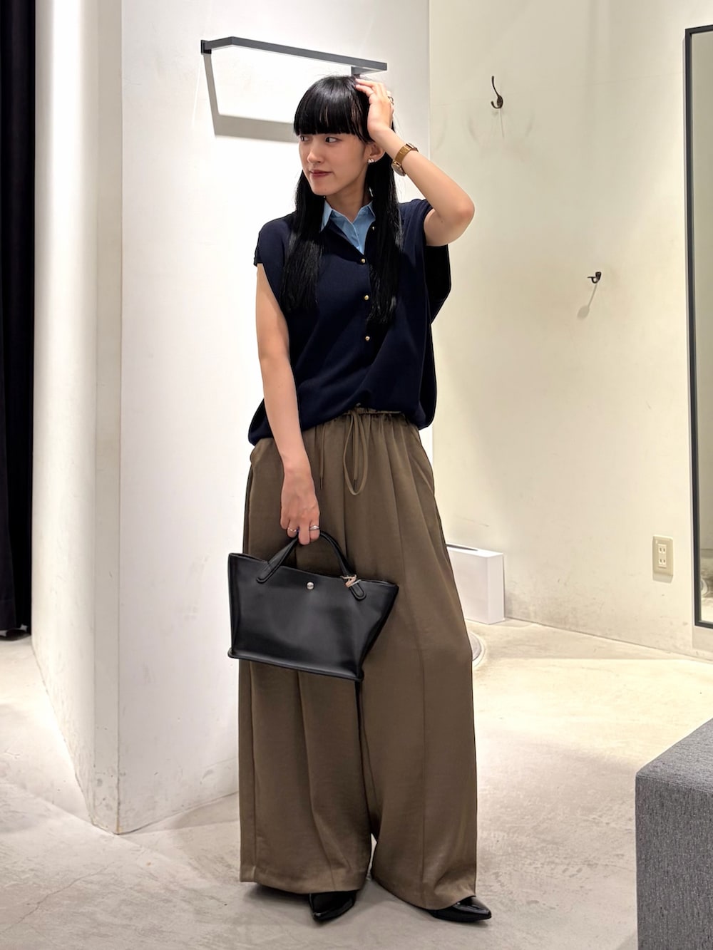 ブルー系のニット/セーター、ベージュ系のその他パンツ、ブラック系のパンプスを着用したレディースの秋コーディネートの5枚目の写真