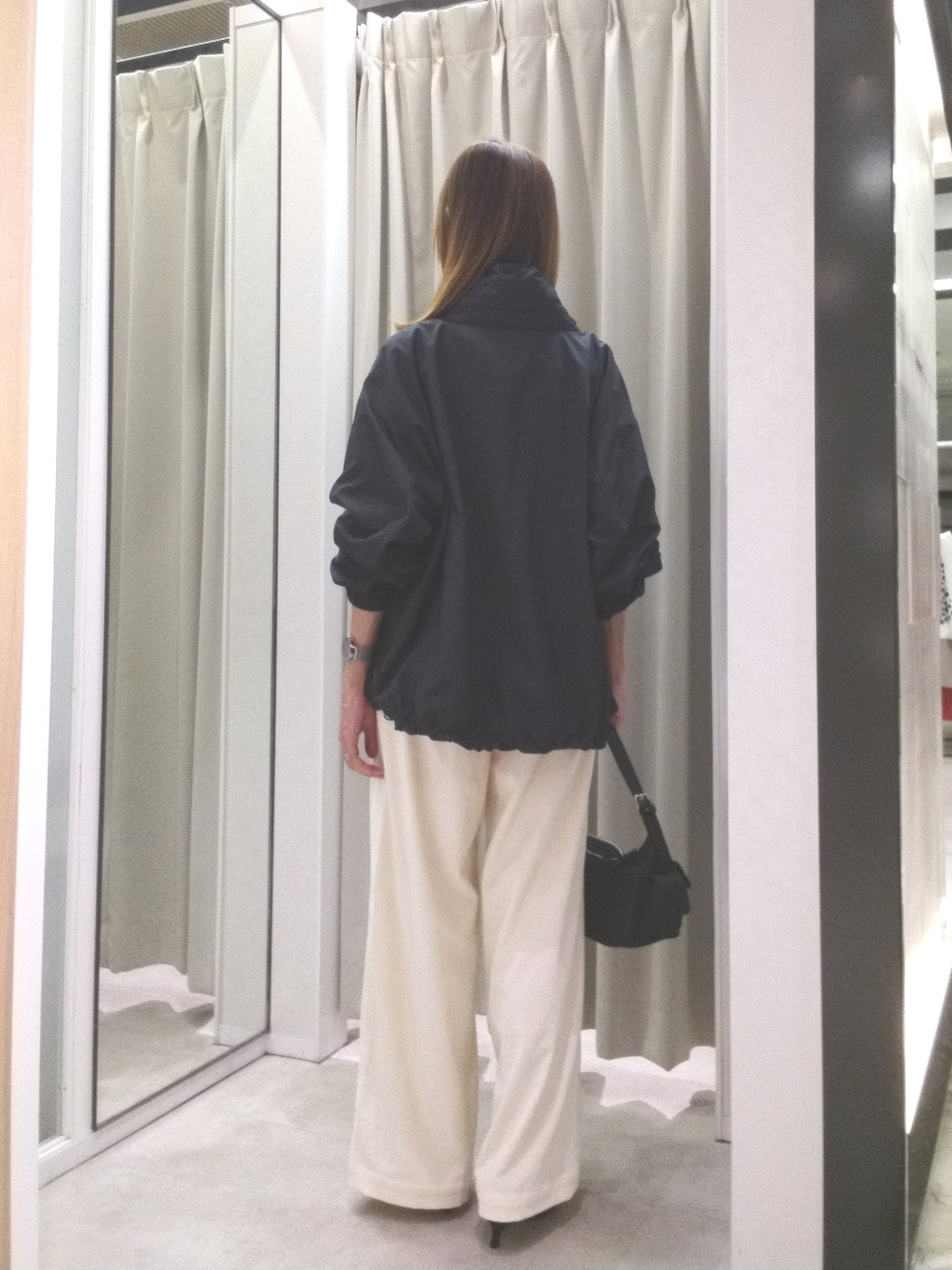 ブラック系のブルゾン、グレー系のニット/セーター、ホワイト系のその他パンツを着用したレディースの秋コーディネートの4枚目の写真