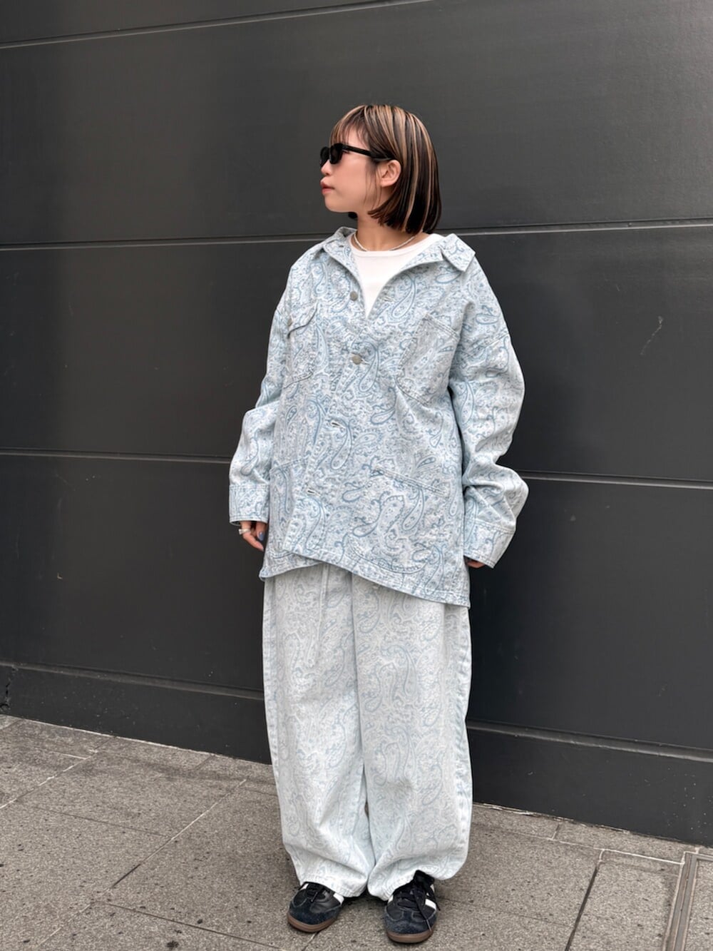 ホワイト系のTシャツ/カットソー、ブルー系のカバーオール、ブルー系のデニムパンツを着用したレディースの春コーディネートの6枚目の写真