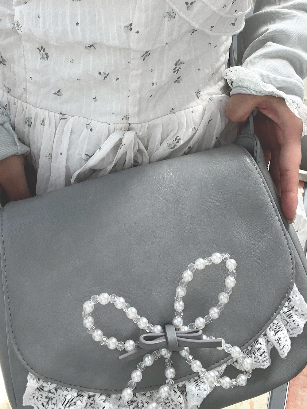 グリーン系のTシャツ/カットソー、ホワイト系のワンピース、ブルー系のショルダーバッグを着用したレディースの春コーディネートの8枚目の写真