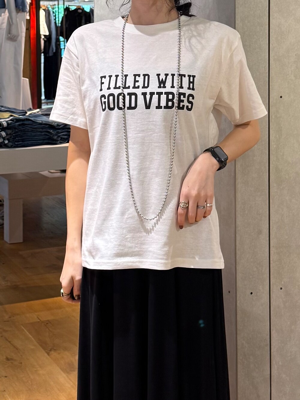ブラック系のスカート、ブラック系のベスト、ホワイト系のTシャツ/カットソーを着用したレディースの夏コーディネートの8枚目の写真