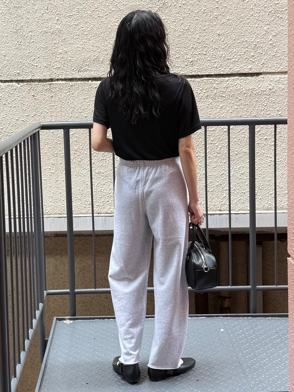 グレー系のその他パンツ、ブラック系のTシャツ/カットソー、ブラック系のショルダーバッグを着用したレディースの夏コーディネートの3枚目の写真