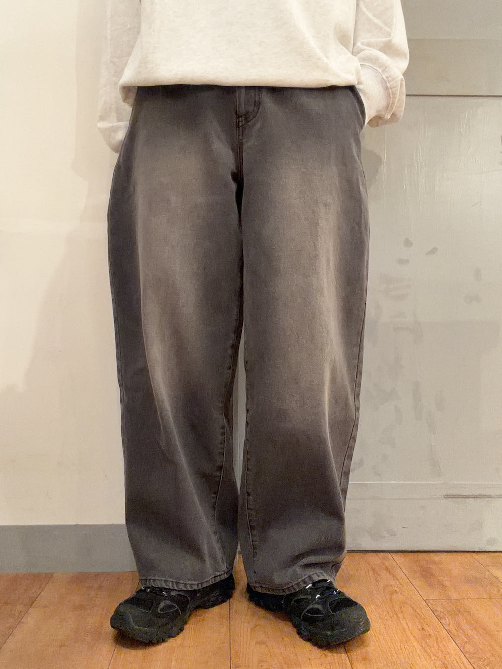 ベージュ系のニット/セーター、ブラック系のデニムパンツ、ブラック系のキャップを着用したレディースの秋コーディネートの6枚目の写真