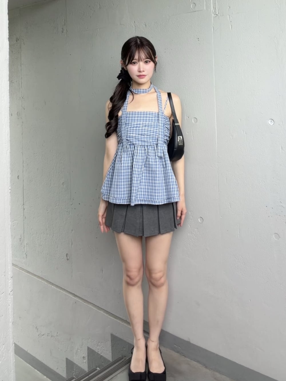 ブルー系のチューブトップ、グレー系のスカートを着用したレディースの夏コーディネートの2枚目の写真