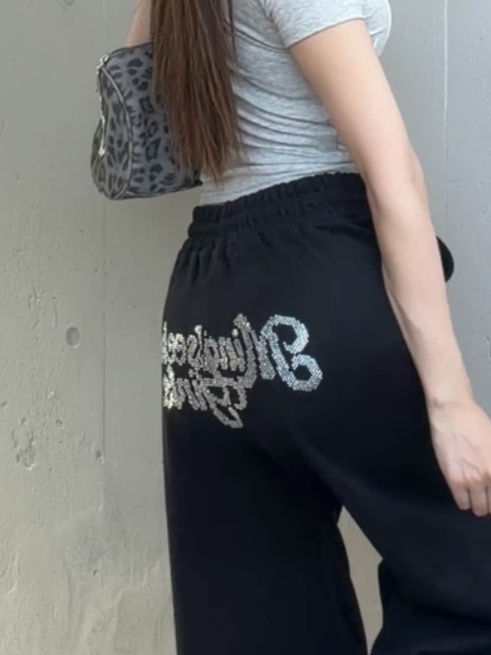 ブラック系のスウェットパンツ、グレー系のTシャツ/カットソー、その他のショルダーバッグを着用したレディースの夏コーディネートの3枚目の写真