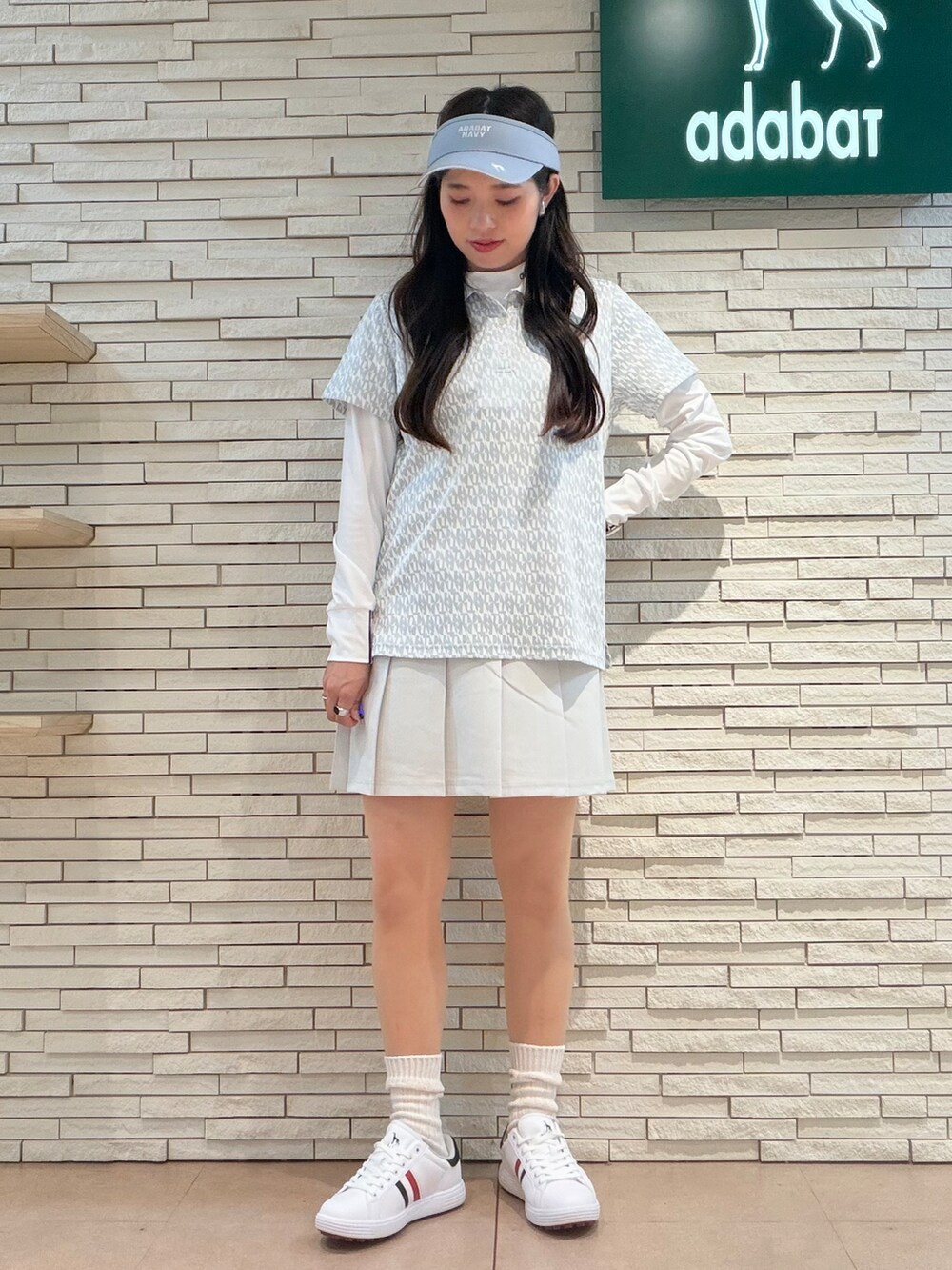 ホワイト系のTシャツ/カットソー、グレー系のポロシャツ、グレー系のスカートを着用したレディースの秋コーディネートの8枚目の写真