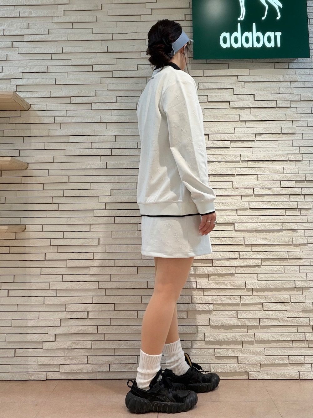 ホワイト系のブルゾン、ブラック系のTシャツ/カットソー、ホワイト系のスカートを着用したレディースの秋コーディネートの4枚目の写真