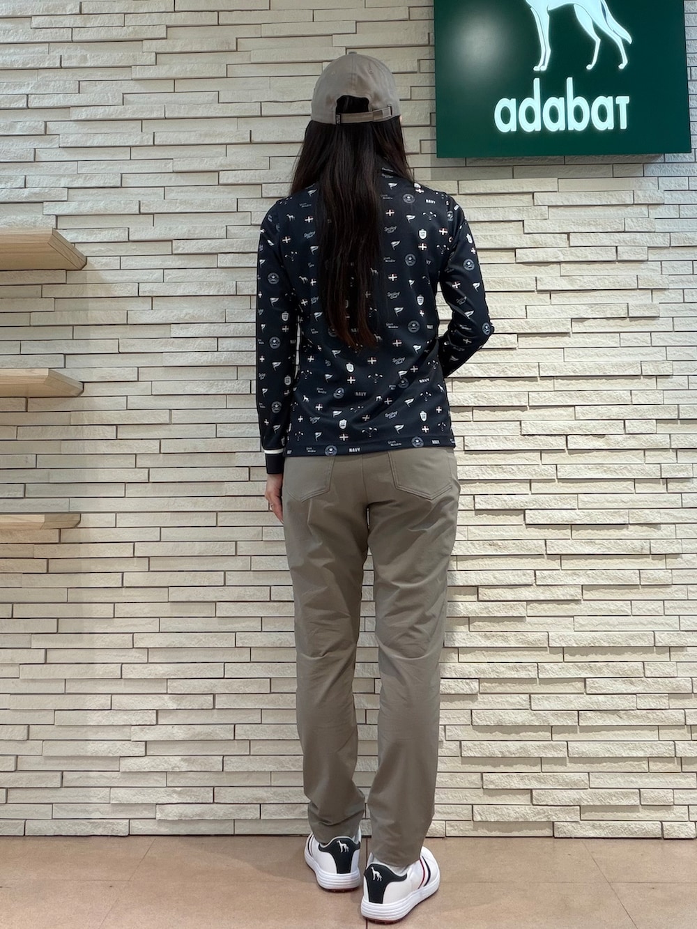 ブルー系のポロシャツ、ベージュ系のその他パンツ、ブルー系のトートバッグを着用したレディースの夏コーディネートの3枚目の写真